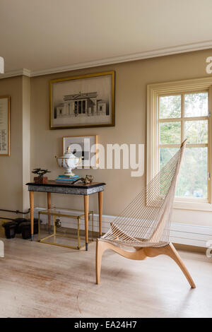 1968 Harp chair by Jorgen Hovelskov in room with limed oak floors, console table and 1810 German tureen. The black and white pho Stock Photo