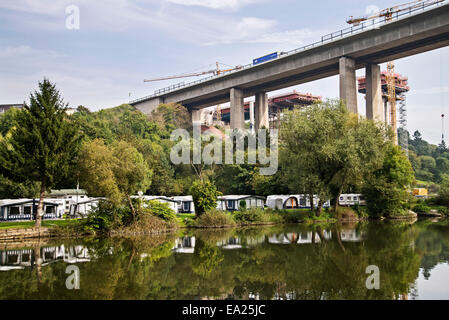 Campground at the Lahn with the old Lahn bridge and the new bridge in the background. Stock Photo