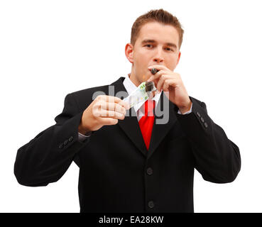 Confident business man lighting a cigar with one hundred euro banknote Stock Photo