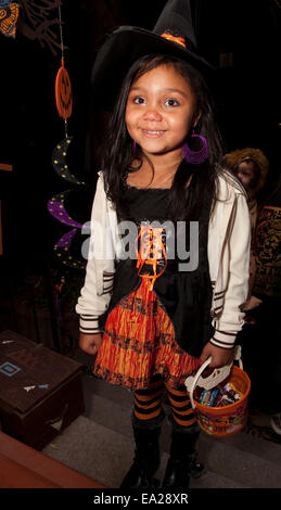 Happy young girl trick or treating in her Halloween witches costume. St Paul Minnesota MN USA Stock Photo