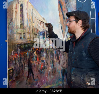 Urban Landscapes of Manchester, Rob Pointon, UK Plein Air artist, working on a themed oil painting, street scenes painted in the city centre, Market St, Manchester. Painting outdoors artwork to be exhibited at the Northern Art specialist in a solo show at the Colourfield Gallery,  Rob Pointon is said to be one of the most exciting artists working and living in the UK. His exceptional talents have been recognized by a host of commissions and acquisitions by high profile collectors, of whom the list is headed by HRH The Prince of Wales. Stock Photo