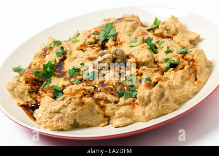Traditional homemade Ottoman circassian chicken, shredded meat in walnut sauce, drizzled with walnut oil coloured with paprika Stock Photo