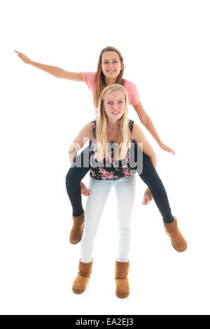 Teen girlfriends have fun in the studio isolated over white background Stock Photo