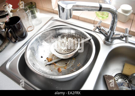 Kitchen conceptual image. Dirty sink with many dirty dishes. Stock Photo