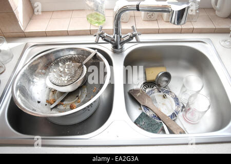 Kitchen conceptual image. Dirty sink with many dirty dishes. Stock Photo