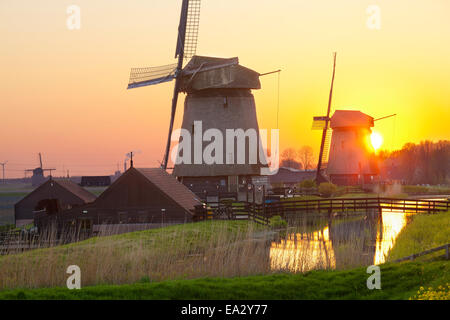 Windmills at sunset, Schermerhorn, North Holland, Netherlands, Europe Stock Photo