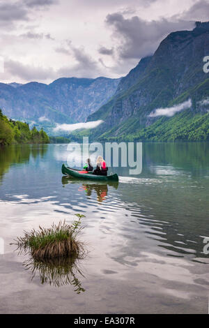 Mother and son canoeing on Lake Bohinj, Triglav National Park, Julian Alps, Slovenia, Europe Stock Photo