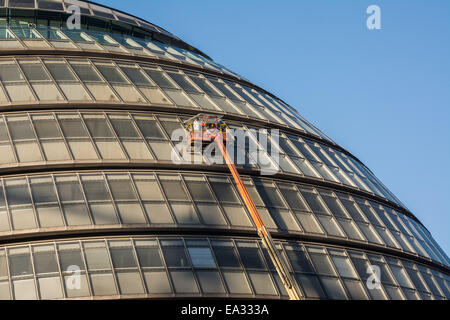 London, UK. 6th Nov, 2014.  Window cleaners work on London's City Hall with a blue winter sky in the background Credit:  Patricia Phillips/Alamy Live News Stock Photo