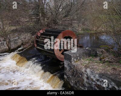 old inoperative water mill on river background Stock Photo