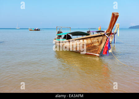 A Longtail boat  in orange beach sand Stock Photo