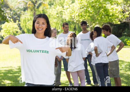 Beautiful volunteer pointing at tshirt Stock Photo