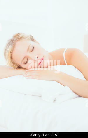 Attractive young blonde sleeping on her bed Stock Photo