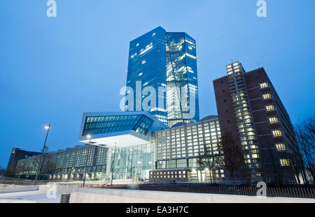 Frankfurt Main, Germany. 05th Nov, 2014. The new European Central Bank headquarters (C) are lit-up in Frankfurt Main, Germany, 05 November 2014. Even though the first ECB staff have already moved into the building, the regular press conference will take place in the old building on November 06. Photo: BORIS ROESSLER/dpa/Alamy Live News Stock Photo