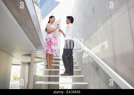 Man offering a red rose to girlfriend Stock Photo