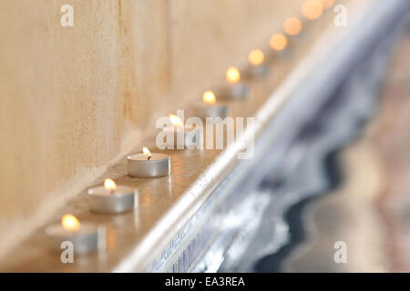 Close up of burning candles near water in a spa interior pool relax concept Stock Photo