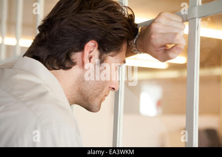 Casual worried businessman leaning on window Stock Photo