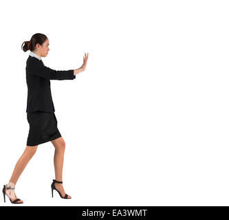 Businesswoman in suit standing and pushing Stock Photo
