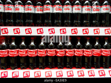 Bottles of Coca Cola fizzy drinks on display on a supermarket shelf ...
