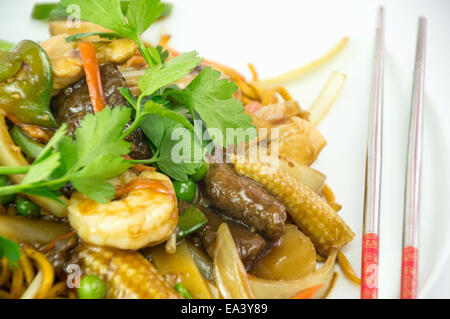 Close up of Chinese fast take away food. Chinese shredded beef with King Prawns. Stock Photo