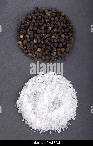 black pepper and coarse salt on slate Stock Photo