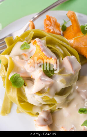 ,,tagliatelle con Spinaci,, with chanterelles Stock Photo