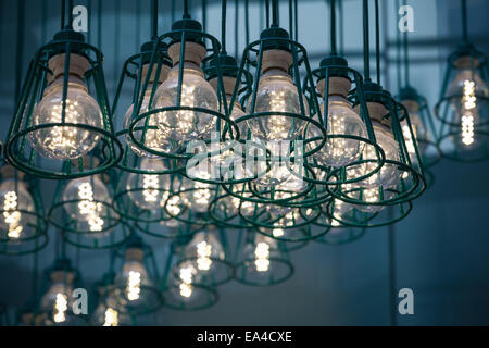 Abstract interior fragment. Stylized vintage illumination with modern LED lamps in metal lampshades Stock Photo