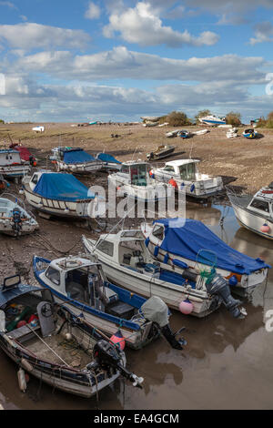 Boats rest gently on the sand, mud and rocks at low tide in the small harbour of Porlock Weir, Somerset . Stock Photo