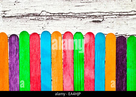 Colorful lollipop sticks on a wooden surface as a background Stock Photo