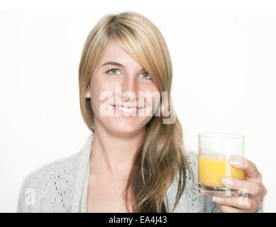 young woman with a glass of fresh orange juice, background white Stock Photo