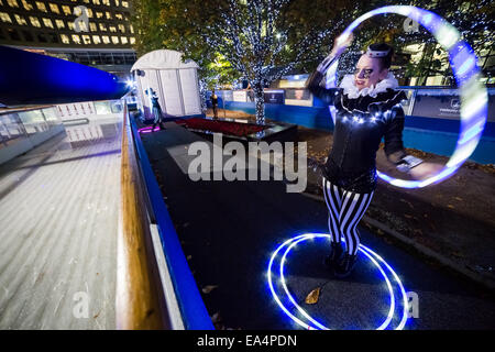 London, UK. 6th Nov, 2014.  Canary Wharf Ice Rink launches with ‘Human Fire Torch’ spectacle Credit:  Guy Corbishley/Alamy Live News Stock Photo