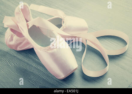 new pink ballet pointe shoes on  wooden background in vintage style Stock Photo