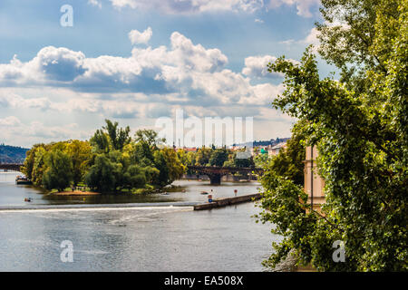 View from Charles Bridge in Prague: Vltava river, Architecture details, tower, church, statue and sculpture of Stock Photo