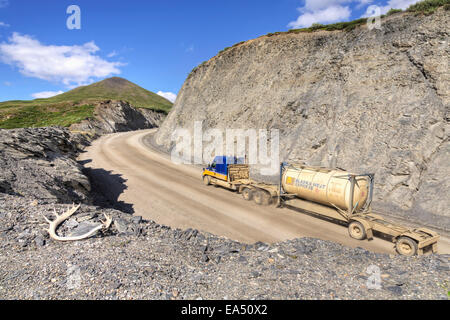 Semi truck driving on the Haul Road (James Dalton Highway) at Chandalar Shelf in the Brooks Range, Arctic Alaska, Summer Stock Photo