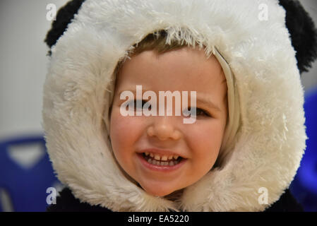 Portrait of a smiling boy in a panda costume Stock Photo