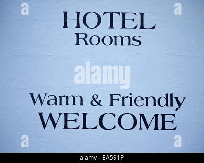 Warm & Friendly Welcome sign painted on outside hotel wall Manchester UK Stock Photo
