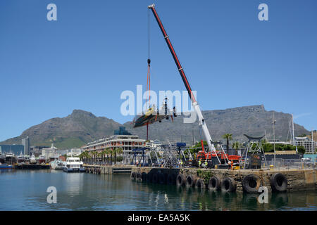 Lead Yacht, Abu Dhabi, is hoisted out of the water for routine repairs before the In Port race and start of the second leg Stock Photo