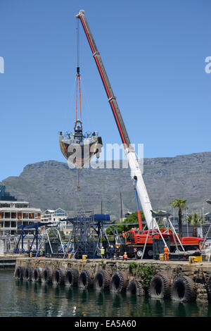 Lead Yacht, Abu Dhabi, is hoisted out of the water for routine repairs before the In Port race and start of the second leg Stock Photo