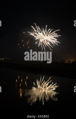 Lewes Bonfire night. A firework display is reflected in the River Ouse Stock Photo