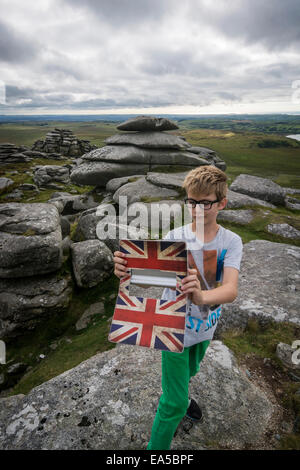 UK, Cornwall, boy photographing himself  at Bodmin Moor with his digital tablet Stock Photo