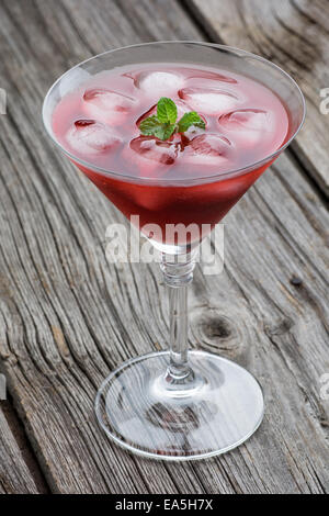 Red Summer martini drink with mint on wooden background Stock Photo