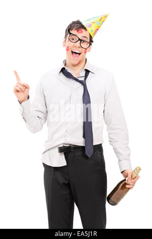 Drunk party guy holding a bottle of champagne isolated on white background Stock Photo