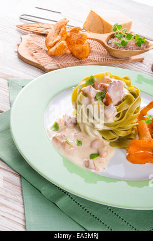 ,,tagliatelle con Spinaci,, with chanterelles Stock Photo