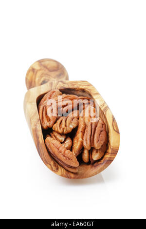 pecan nuts in wood scoop, isolated on white background Stock Photo