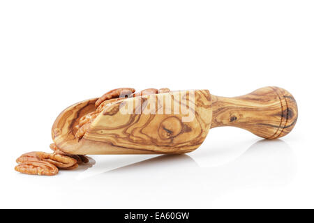 pecan nuts in wood scoop, isolated on white background Stock Photo