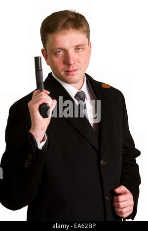 man in a suit aims from a pistol Stock Photo