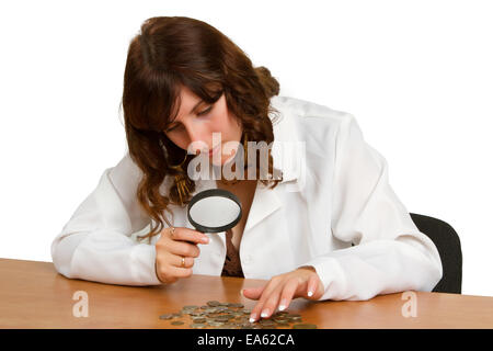 hand hold magnifying glass and coins Stock Photo