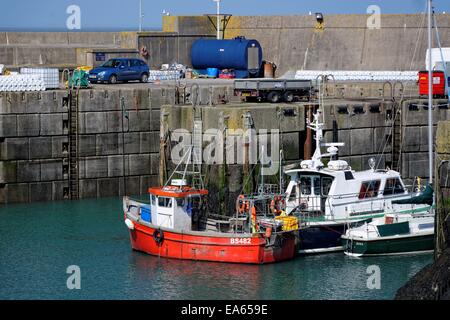 A view of fishing boats at the Port of Amlwch, Anglesey on a calm summer's day. Stock Photo