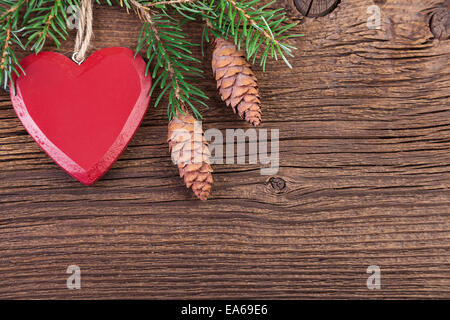 Red Heart with Fir Branch on a Wooden Background Stock Photo