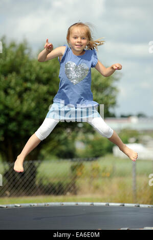 Italia, Calabria, Girl (2-3) jumping on trampoline in summer Italia, Calabria, Girl (2-3) jumping on trampoline in summer