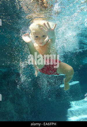 Underwater boy in the swimming pool. Cute kid boy swimming in pool ...